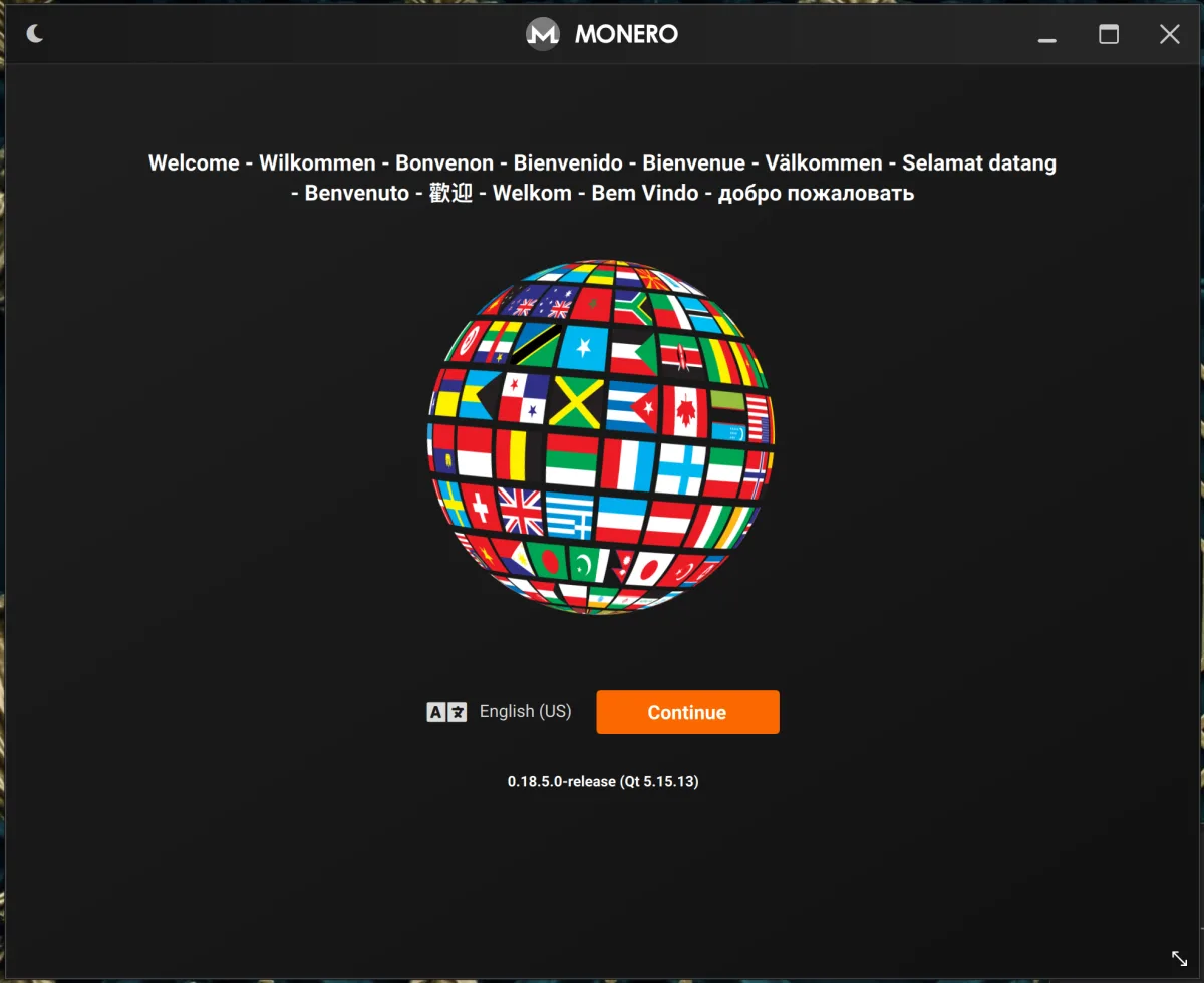 Monero app first-run welcome screen with the language globe